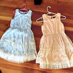 Two twin girl party dresses. one light pink, one light blue. size 10